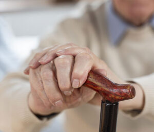 Elderly man with cane representing financial exploitation